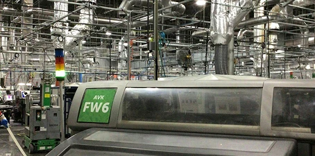 Industrial manufacturing cleaning—rows of heavy machinery and ventilation systems inside a production facility.